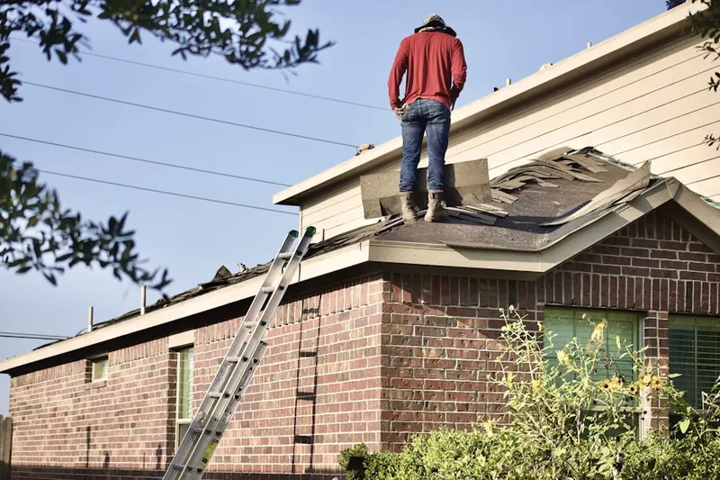 Professional roofer working on a residential roof in East Ridge